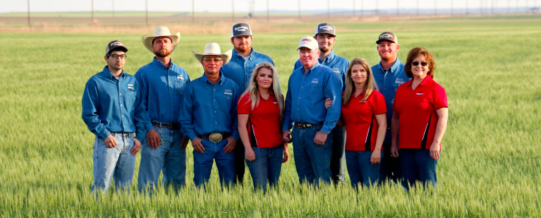 The Whitewater Irrigation team standing in a green wheat field